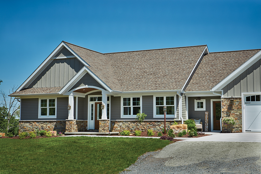 White framed double-hung windows as seen from the exterior of a newly built home